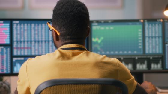Black person trading on stock exchange from home