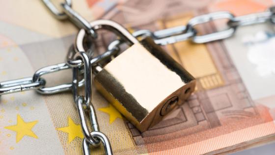 Chain and padlock around euro notes